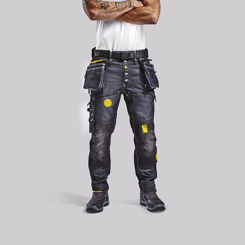 Close-up of Blåkläder craftsman work trousers with reinforced panels, tool pockets and visible wear, showcasing durability and built‑to‑last design.